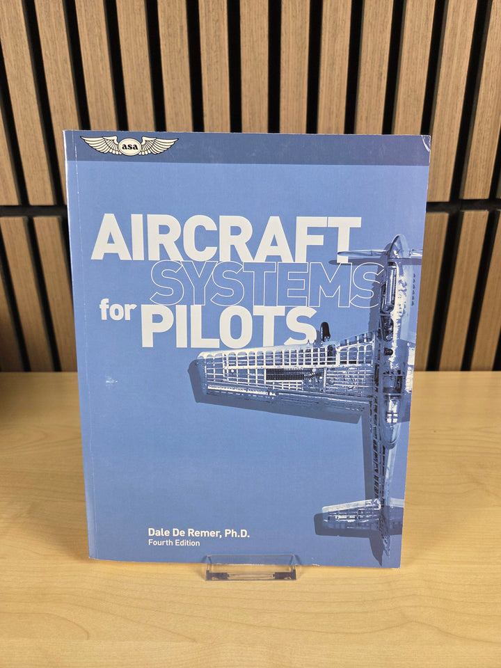 Book titled 'Aircraft Systems for Pilots' on a wooden surface