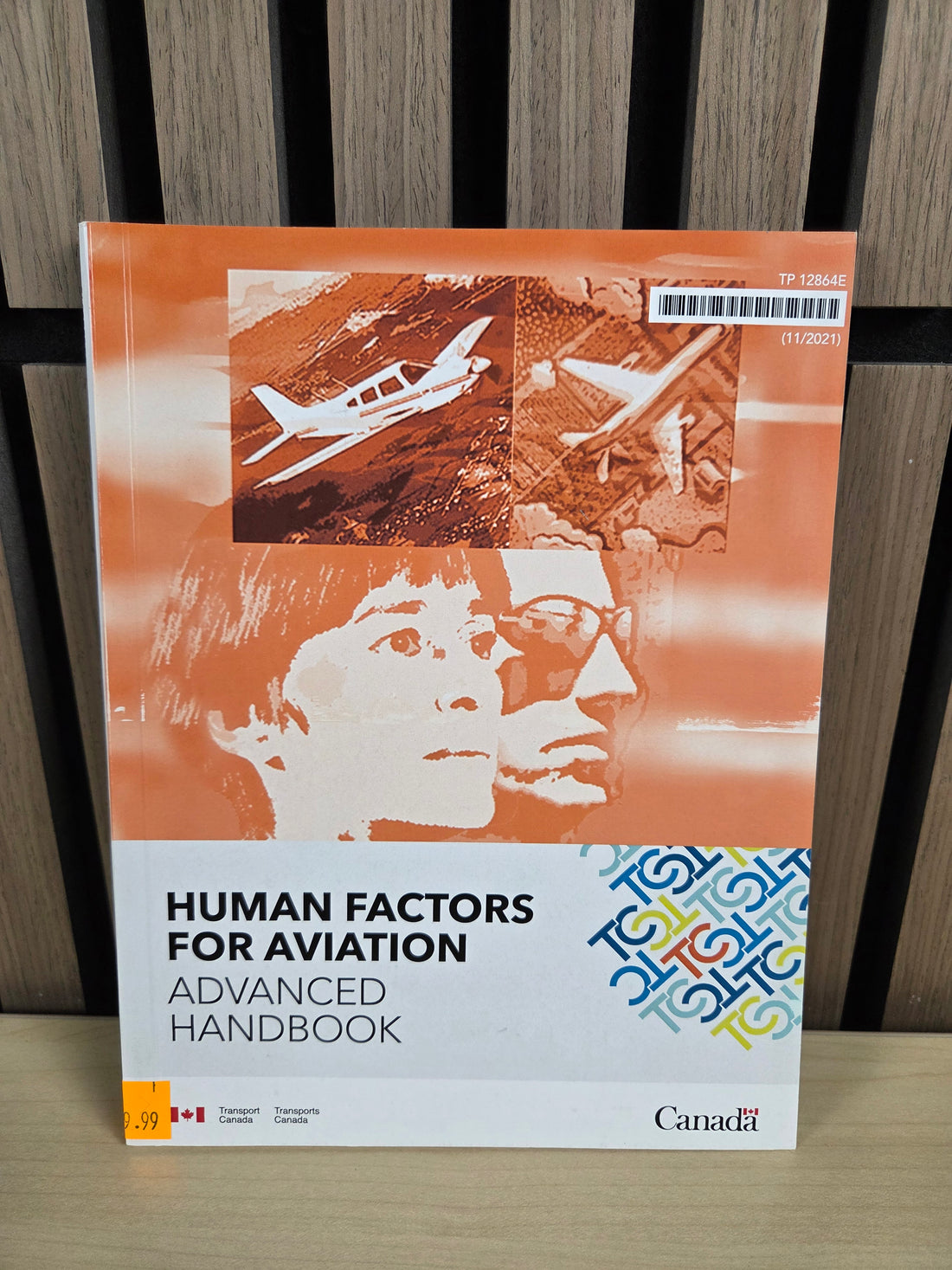 Book titled 'Human Factors for Aviation' on a wooden surface