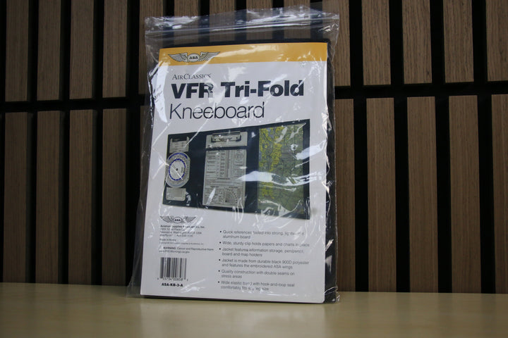 Packaged VFR Tri-Fold Kneeboard on a wooden surface with a striped background