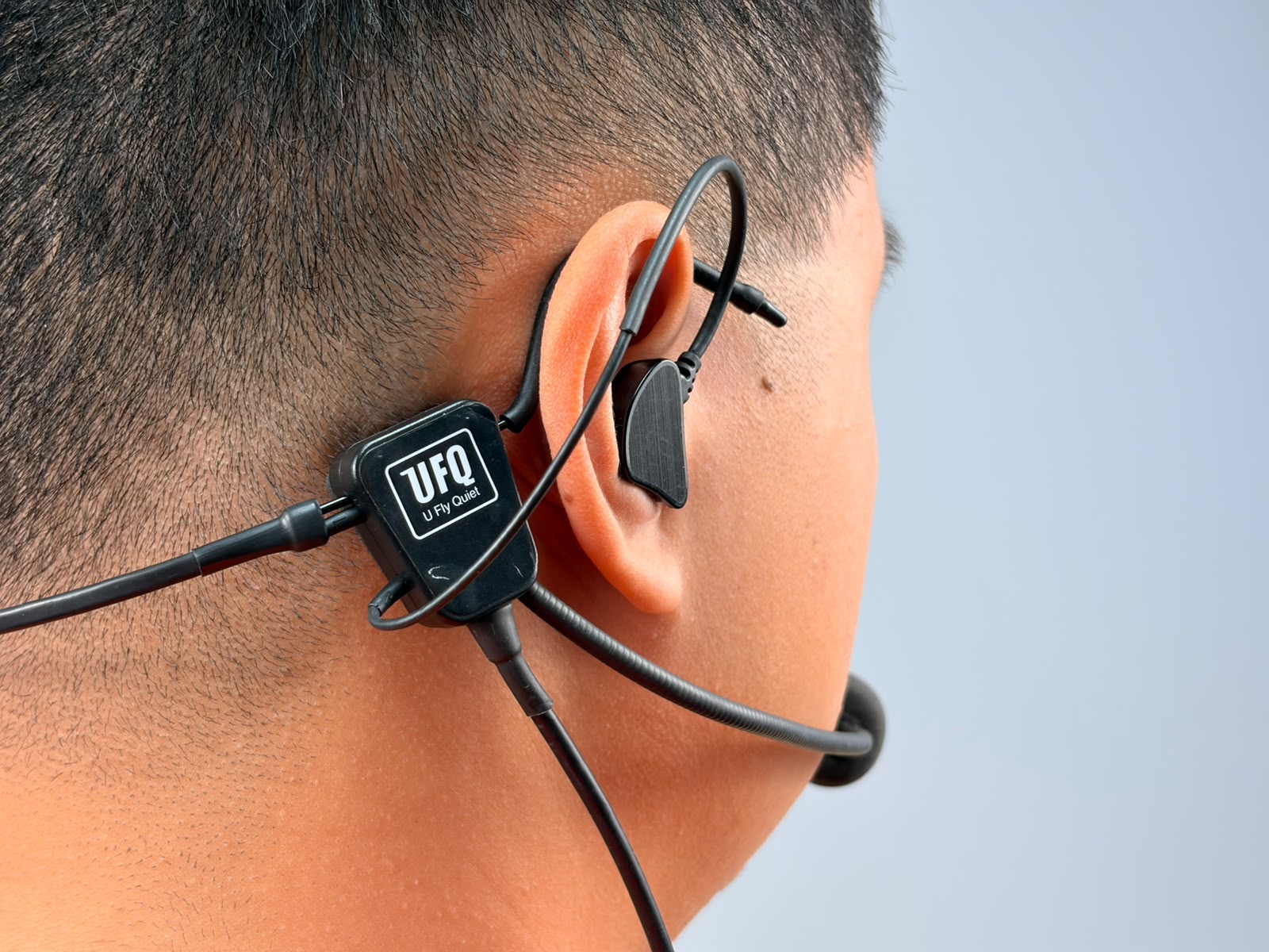A person wearing UFQ L2 aviation headset, close up shot 