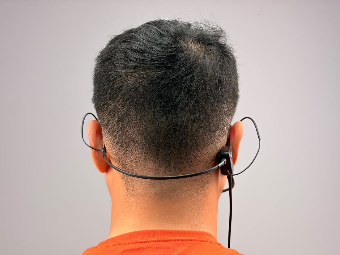 A person wearing UFQ L2 aviation headset, picture taken from behind