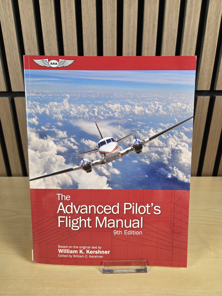 Book titled 'The Advanced Pilot's Flight Manual' on a wooden surface with a helicopter image on the cover.